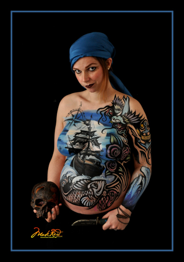 body painted woman in a blue bandana and holding a skull