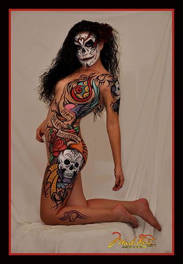 Woman body painted in skull face New Orleans style