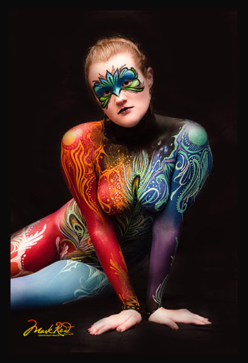 Model with blonde hair in colorful full body paint