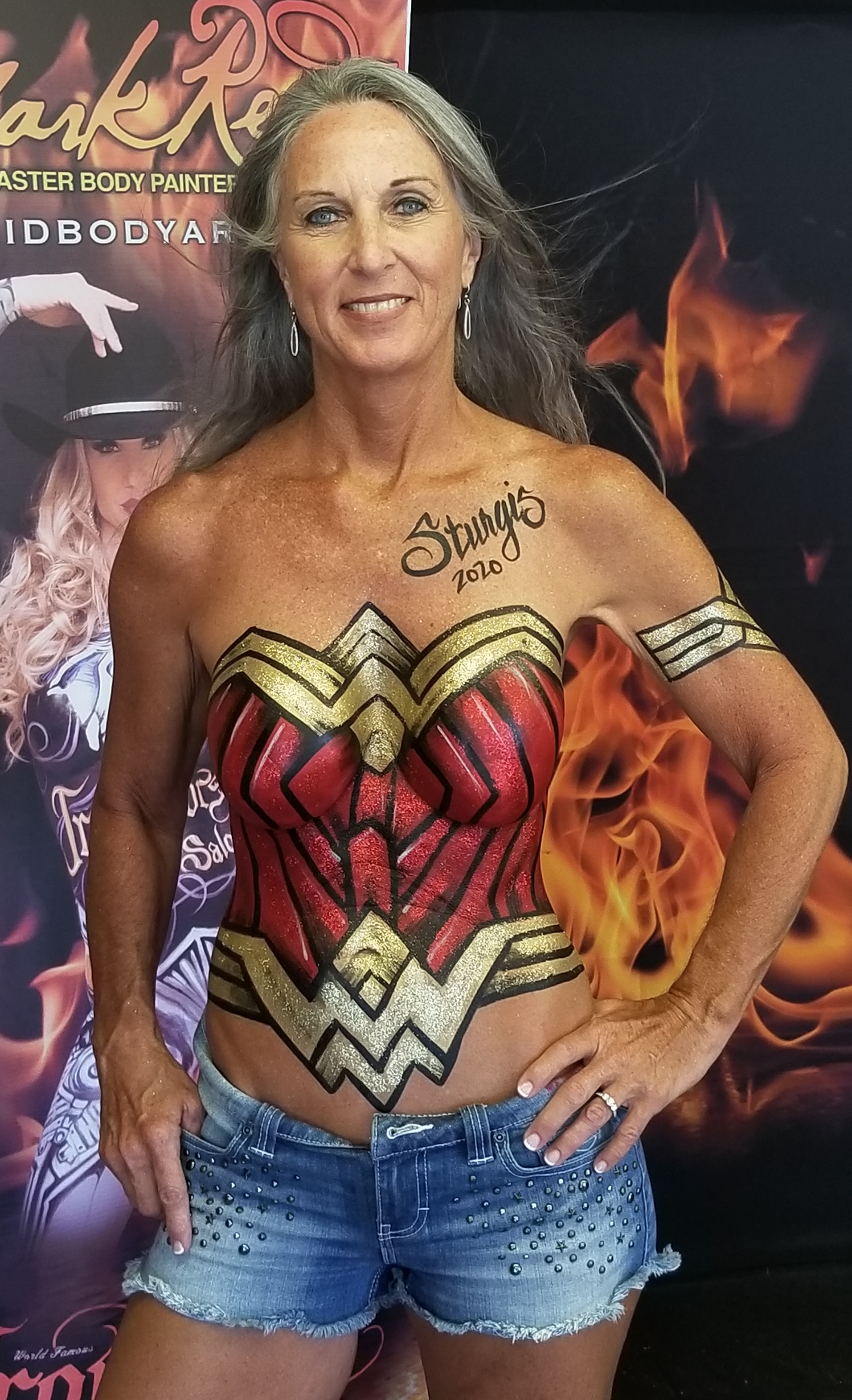 long haired blonde model with a wonder woman super hero costume painted on her top half