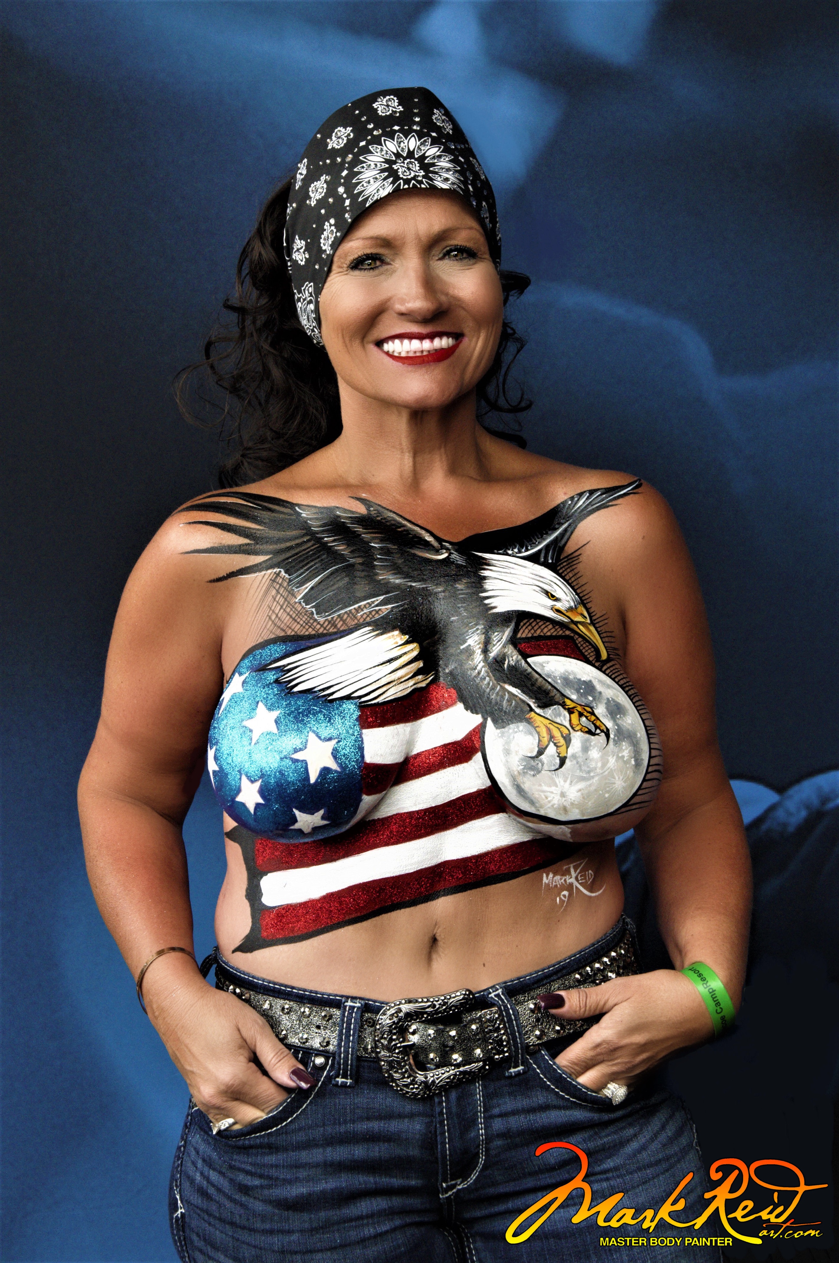 model with a detailed body painting featuring an eagle and the moon over the american flag